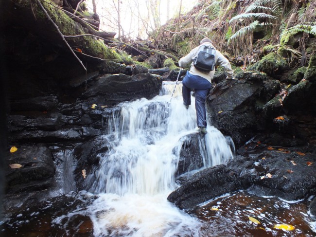 Gordon scaling a waterfall