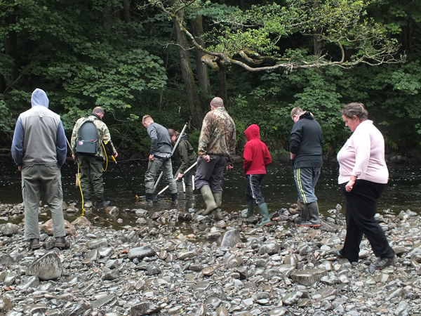 Balsam bashers from Colmonell watching an electrofishing demonstration 