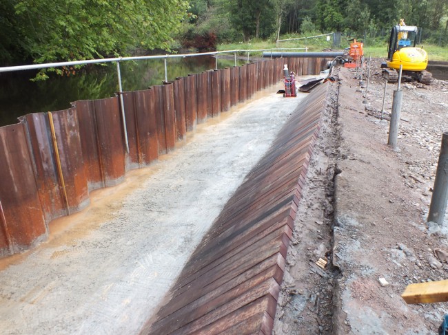 The new timbers fitted to the face of the dam to protect it for the next few hundred years.