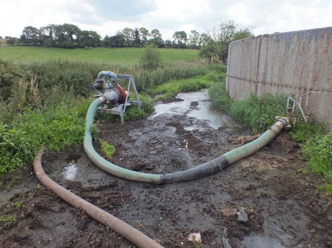 The sight that faced us on arrival at our site. Apart from a hose that is taped up, evidence of slurry spilling over the top of the tank and a shin deep pool of slurry with a steady flow of liquid entering the burn, there wan't much wrong with the location.