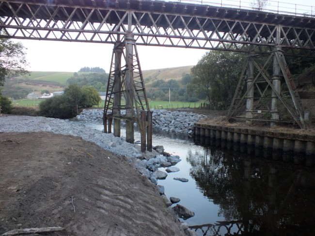 Looking upstream towards the new and inappropriate rock armour. Water used to flow on both sides of the bridge pier in the centre of the photo.